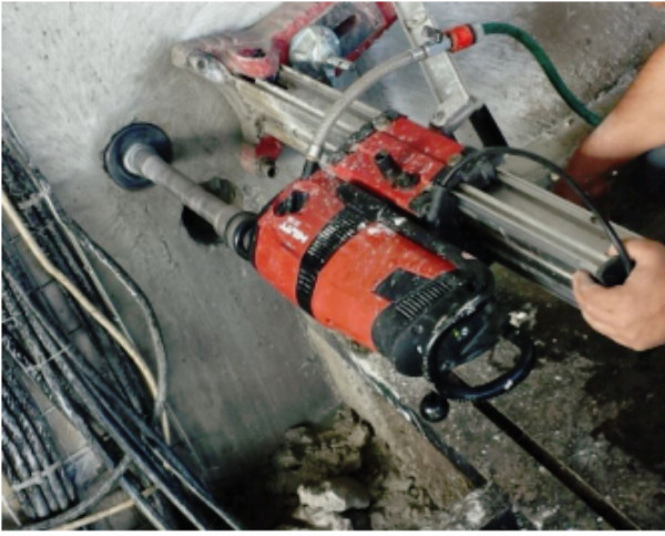 Diamond core drilling rig at work on concrete